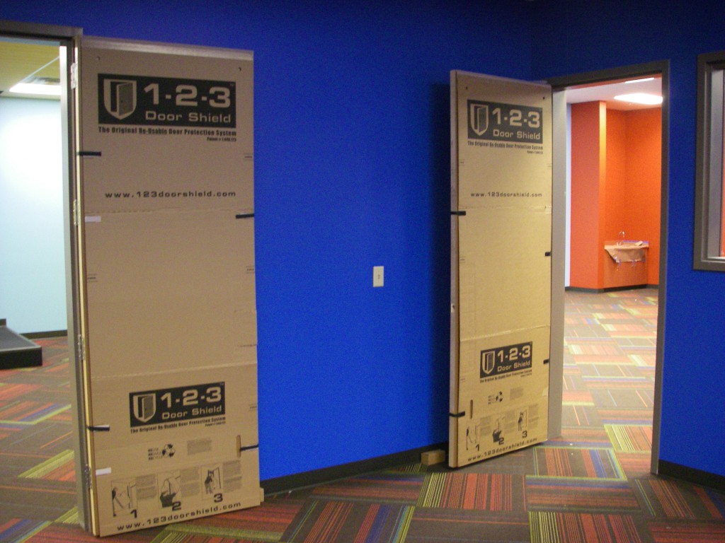 Hospital hallway with temporary wall and door protection
